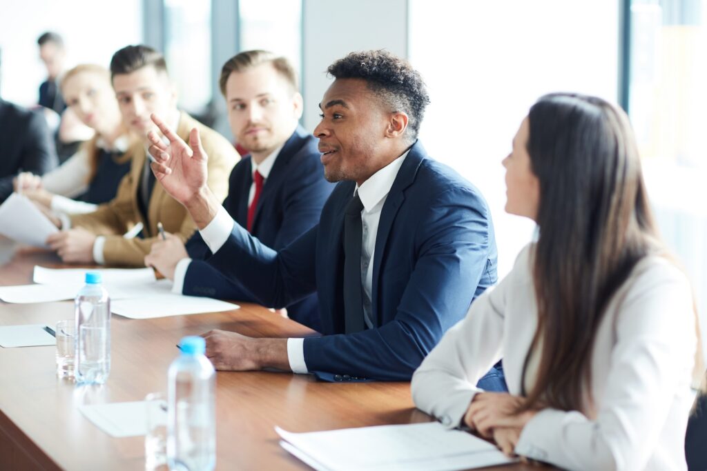 Multiracial people in suits having a meeting