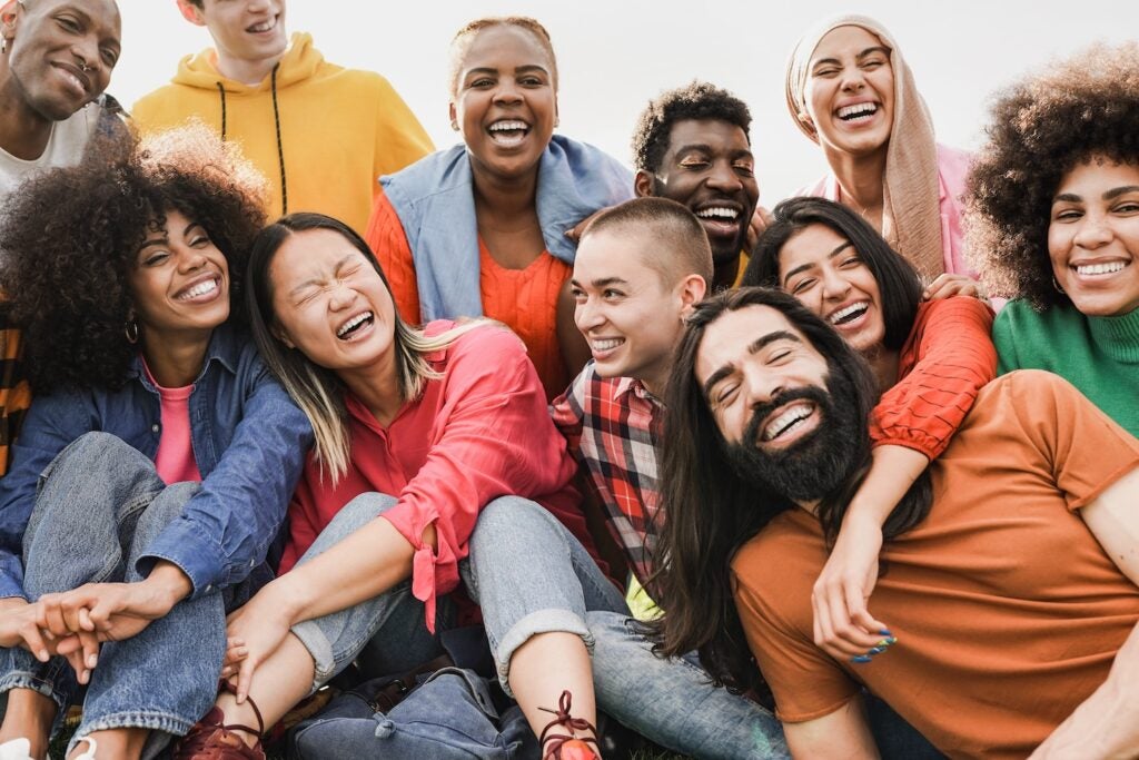 Happy young people having fun together outdoors