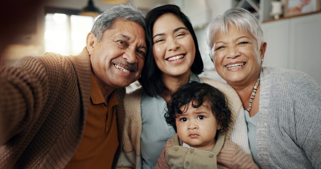 Multigenerational family including older man, older woman, younger woman, and baby