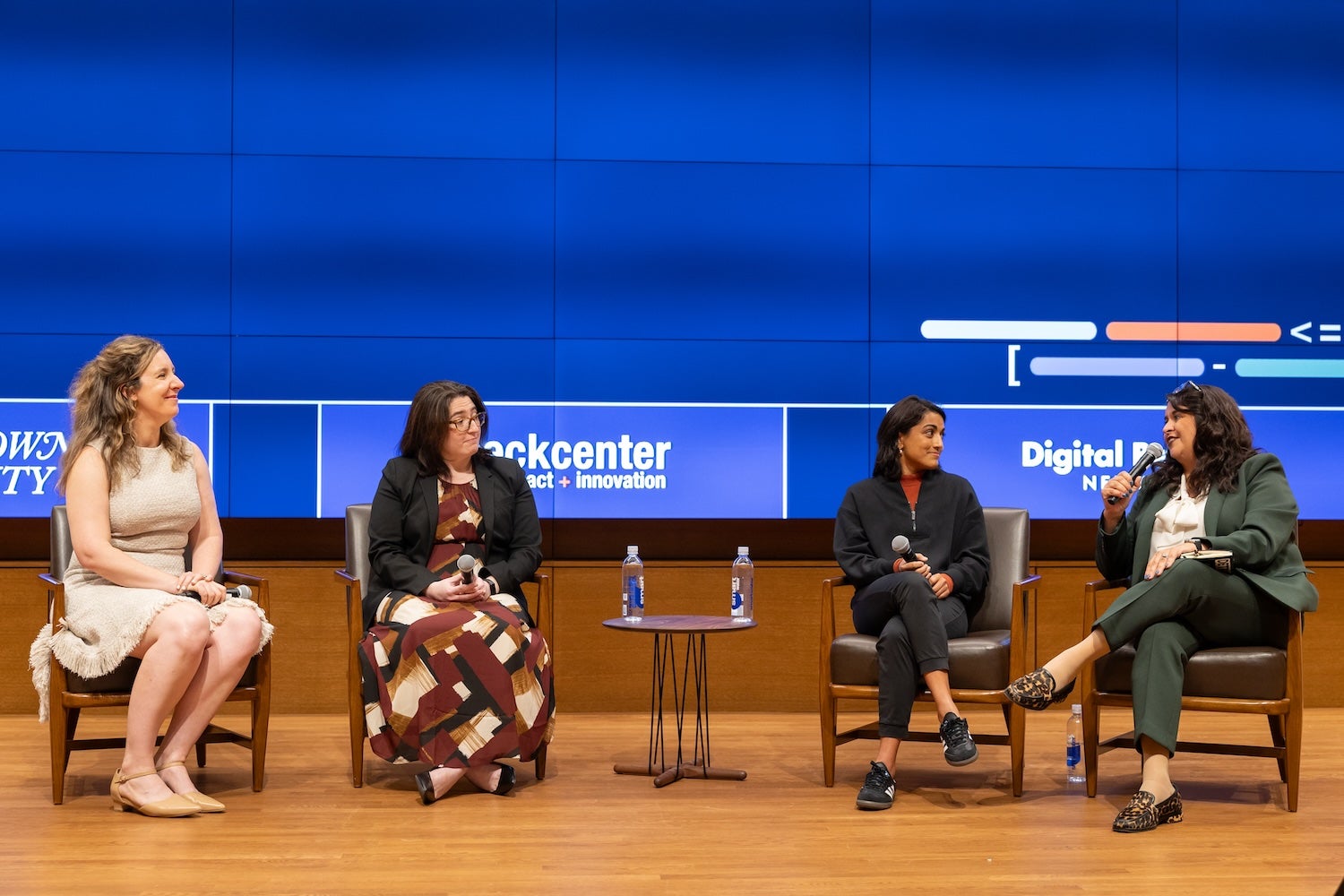 Ariel Kennan, Ayushi Roy, Julia Almendarez Dale, and Julia Simon-Mishel on stage during a panel. 